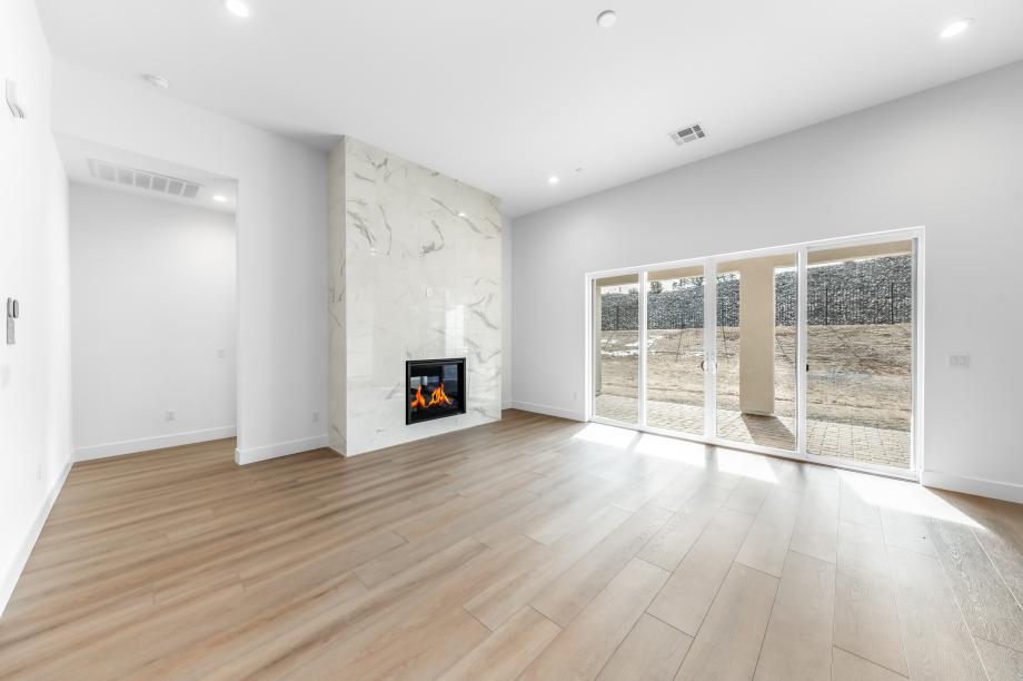 Cozy fireplace in the great room with an abundance of natural light