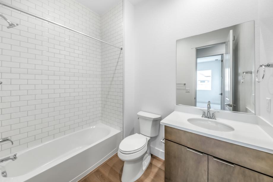 Secondary bathroom with a tub/shower combination with tile surround