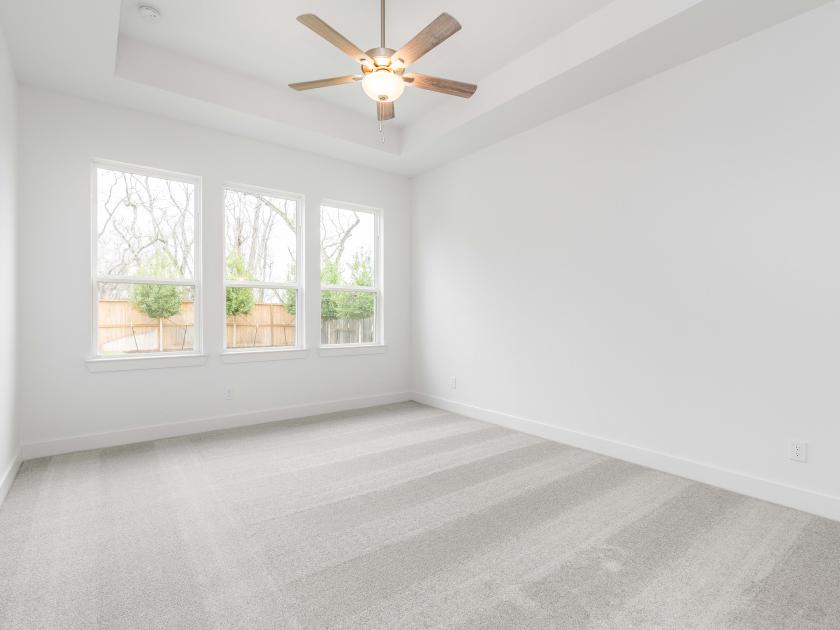 Primary bedroom with tray ceilings