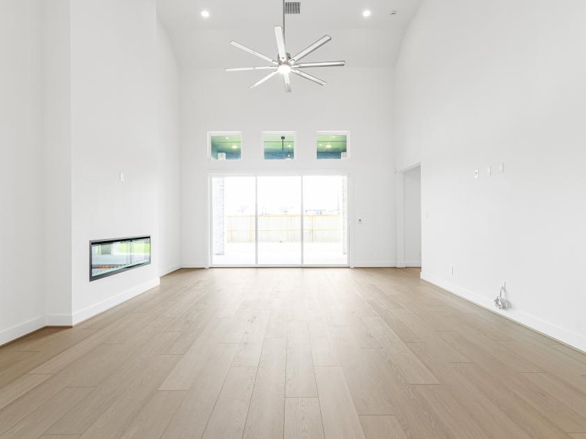 Spacious great room with a sliding glass door and cozy fireplace