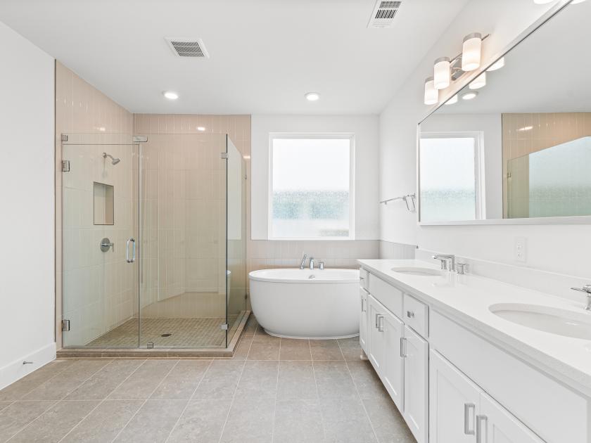 Spa-like primary bathroom with freestanding soaking tub and large walk-in shower