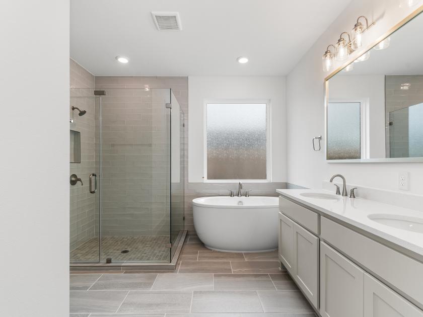 Spa-like primary bathroom with freestanding soaking tub and large walk-in shower