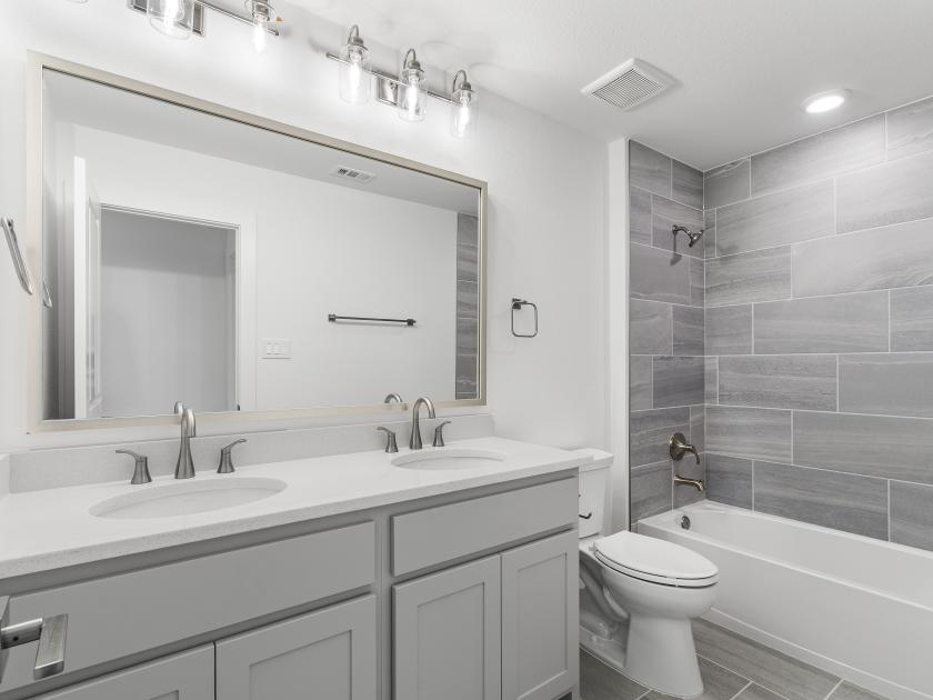 Secondary bathroom with a dual-sink vanity
