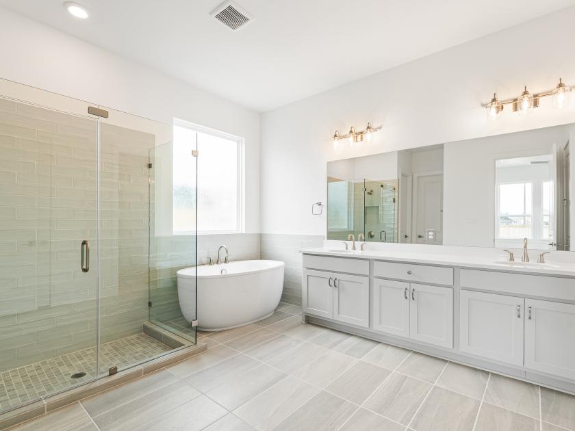 Spa-like primary bathroom with a large walk-in shower and freestanding soaking tub
