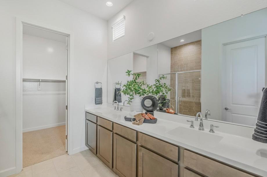 Serene primary bathroom with glass shower door and dual-sink vanity