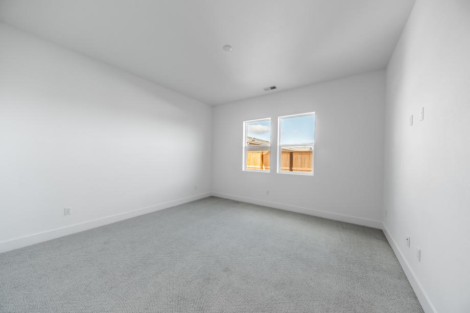 Large primary bedroom suite with ample natural light