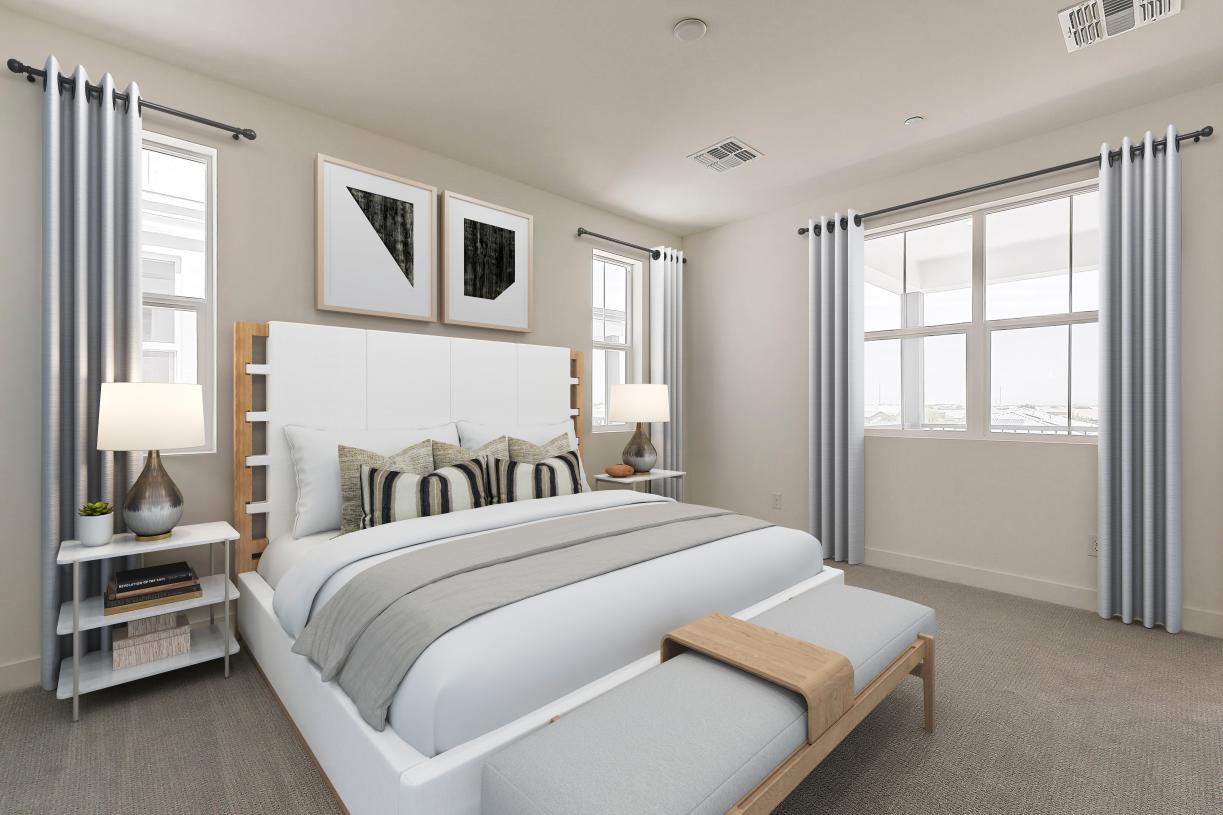 Spacious primary bedroom with ample natural light