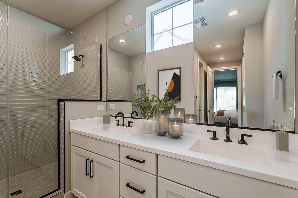 Gorgeous primary bathroom with dual-sink vanity and glass shower door
