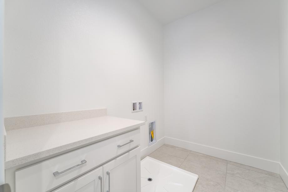 Spacious laundry with cabinets