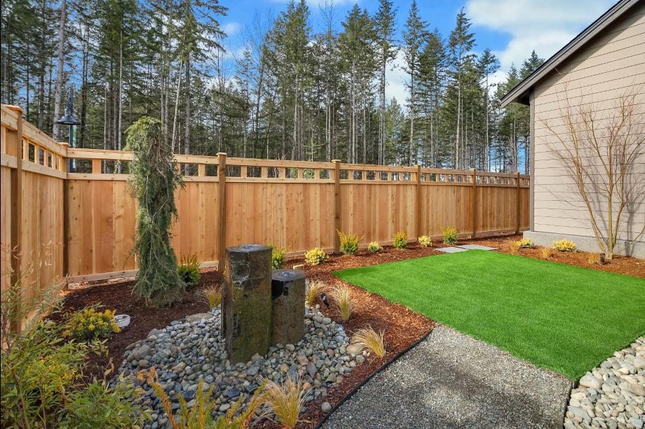 Fenced rear yard includes a water feature