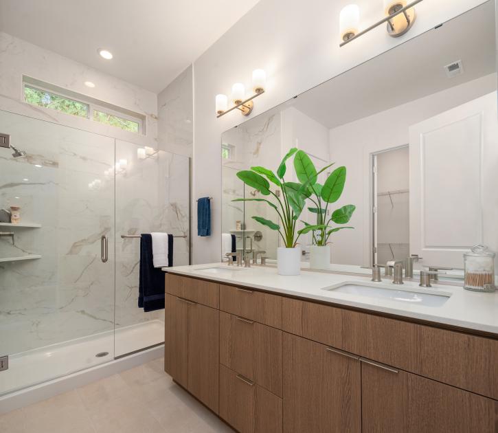 Primary bathroom with dual-sink vanity and walk-in shower