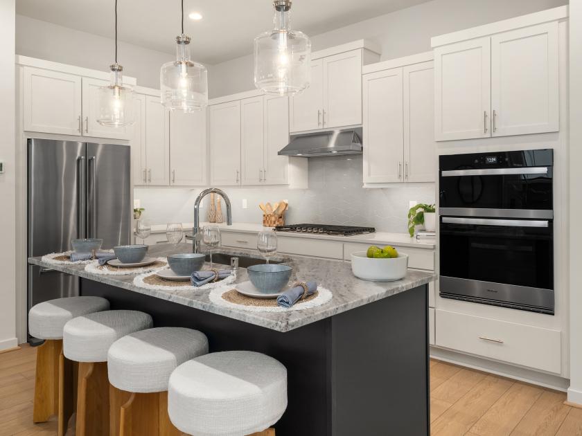 Kitchen island boasts a beautiful dolomite slab countertop with contrasting painted navy cabinets