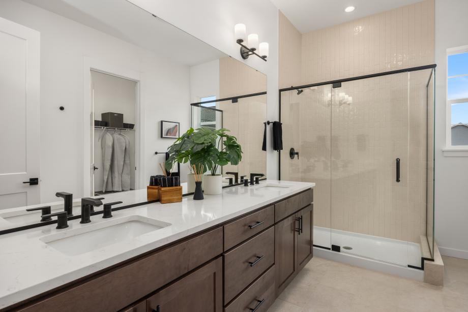 Primary bathroom with dual-sink vanity and walk-in shower