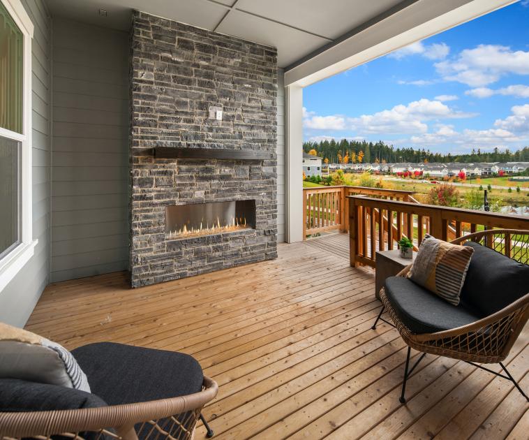 Covered outdoor living with a gas fireplace and territorial views