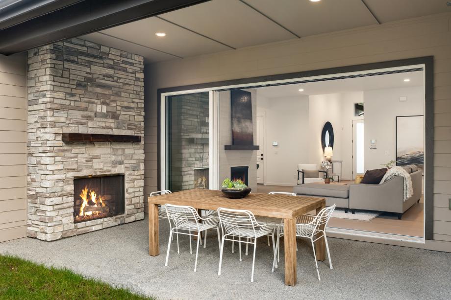 Large covered patio with gas fireplace provides seamless indoor-outdoor living