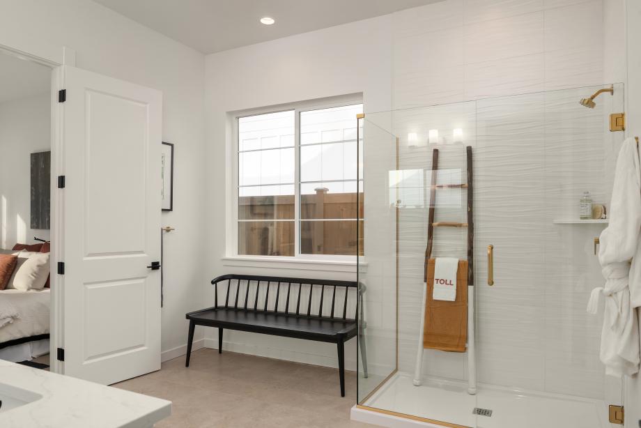 Primary bathroom features a dual-sink vanity and walk-in shower with frameless glass enclosure