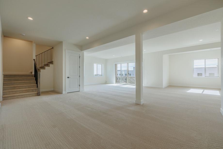 Additional living and bedroom space in the finished basement with 10-foot ceilings