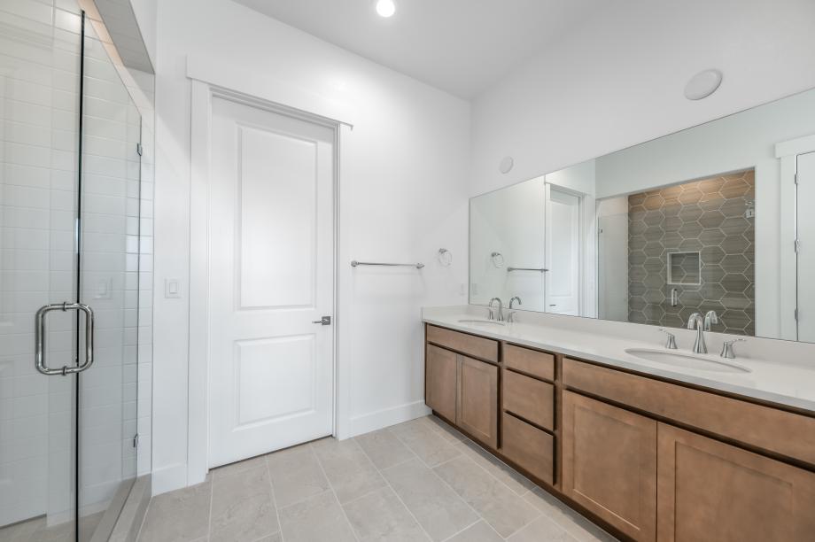 Primary bathroom with walk-in shower and dual-sink vanity