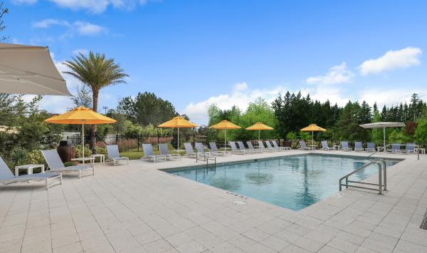 Inviting poolside retreat with shaded seating and vibrant outdoor gathering spaces