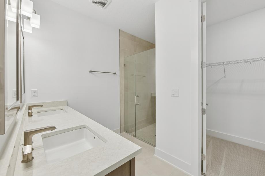 Primary bathroom with walk-in shower and dual-sink vanity