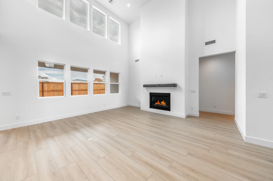 Great room with tall ceilings and a cozy fireplace