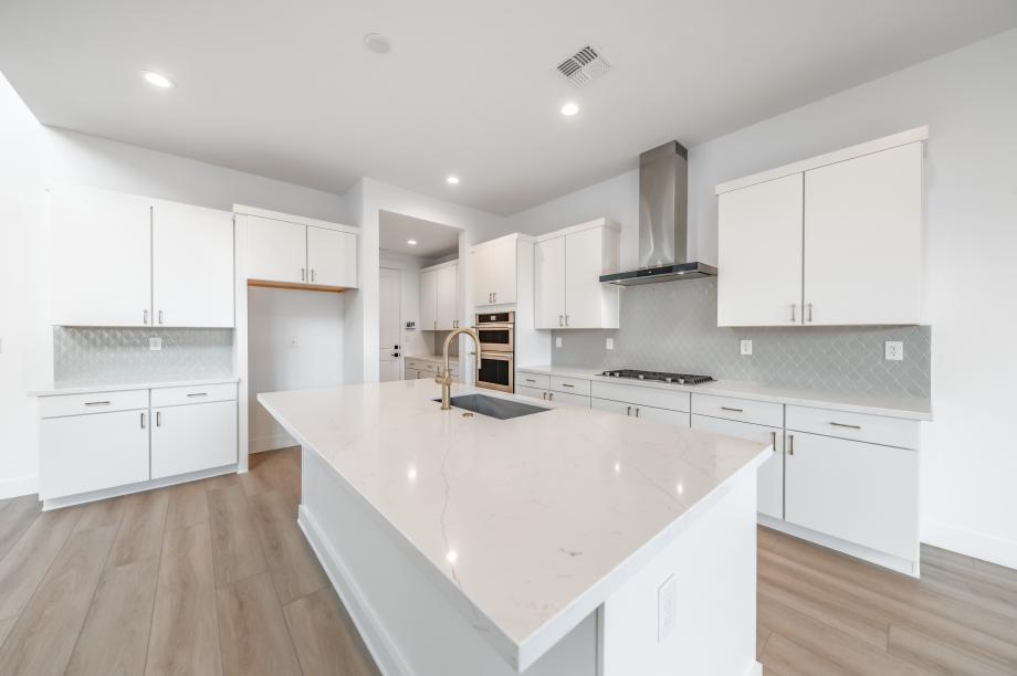 Well-equipped kitchen with white cabinets and ample countertop space