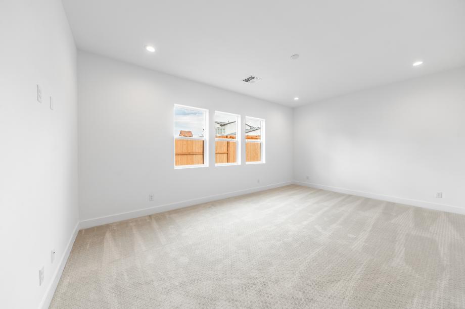 Large primary bedroom suite with ample natural light
