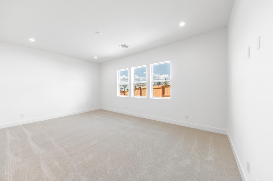 Large primary bedroom suite with a seating area and ample light