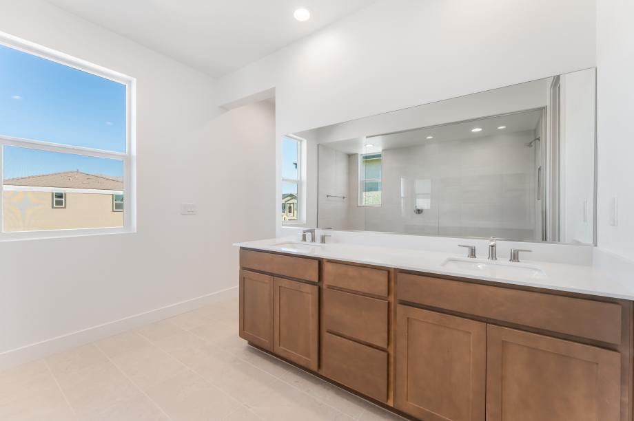 Luxe primary bath with separate dual vanities