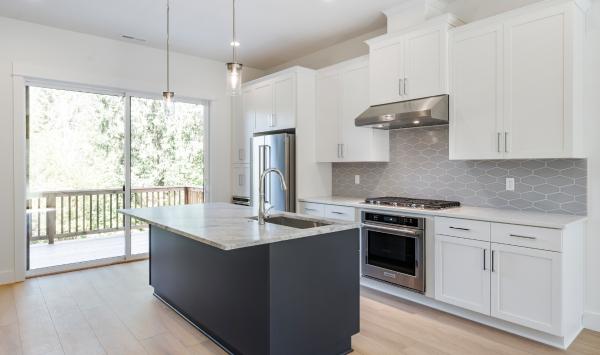 Kitchen boasts a large central island with breakfast bar