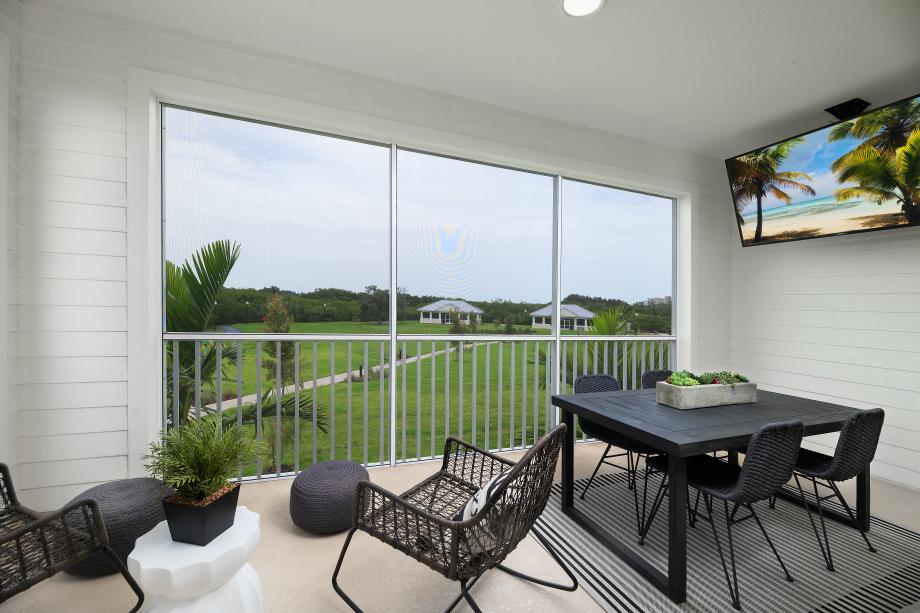 Covered and screened-in lanai provides relaxing views of community amenities and bayou