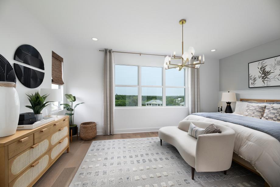 Spacious primary bedroom with views of the amenity and bayou