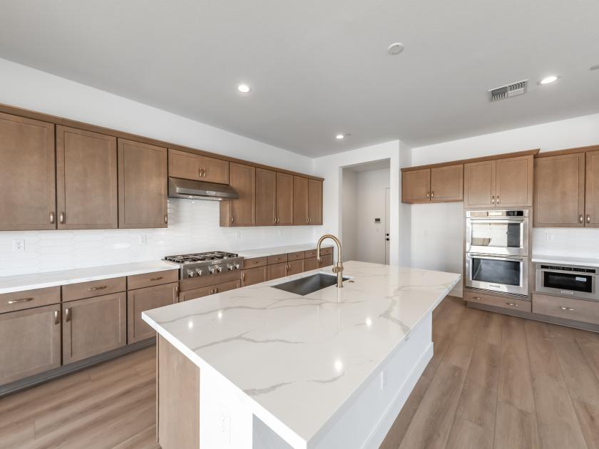 Well-equipped kitchen with quartz countertops and a large center island