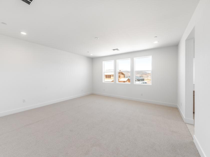 Large primary bedroom suite with ample natural light