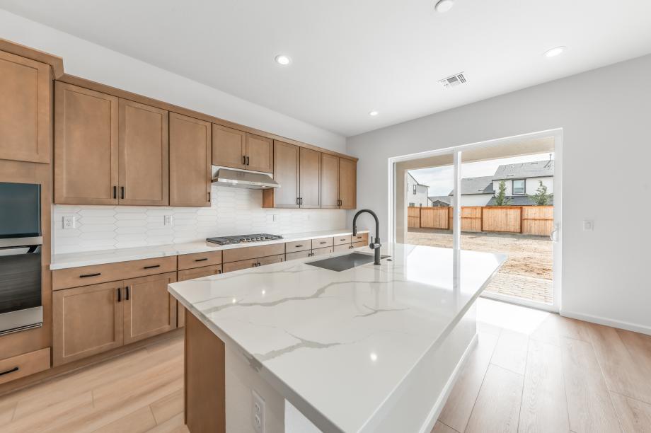 Spacious kitchen with a sliding glass door connecting indoor-outdoor living