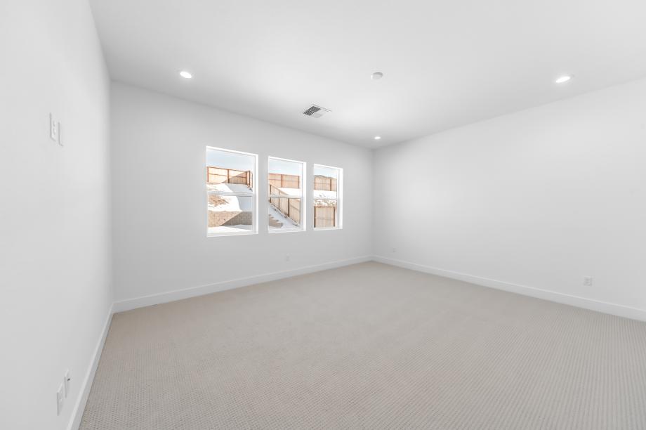 Large primary bedroom suite with ample natural light