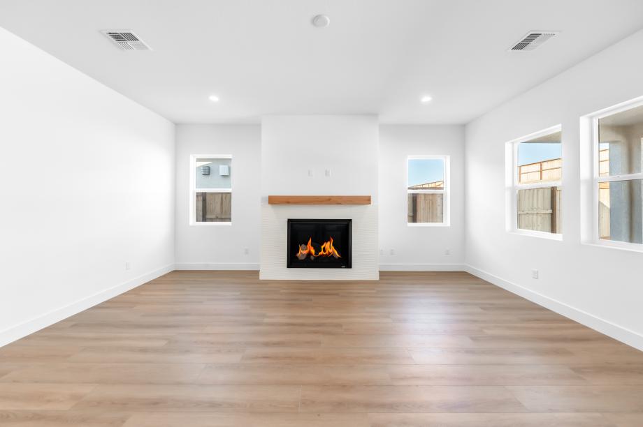Cozy fireplace in the great room with an abundance of natural light