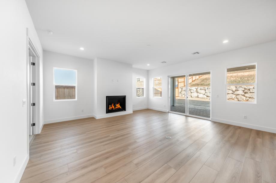 Cozy fireplace in the great room with an abundance of natural light