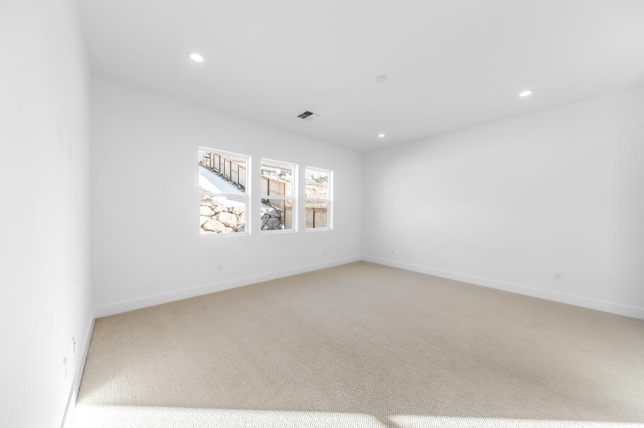 Large primary bedroom suite with a seating area and ample light