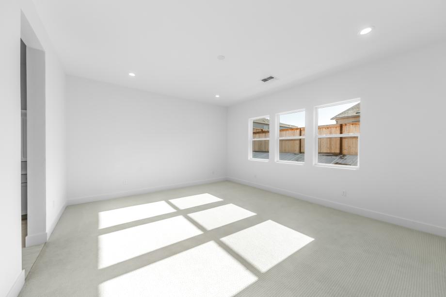 Large primary bedroom suite with a seating area and ample light