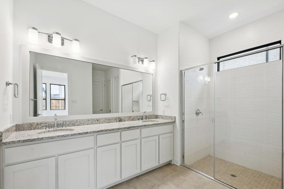 Luxurious primary bathroom with dual vanities