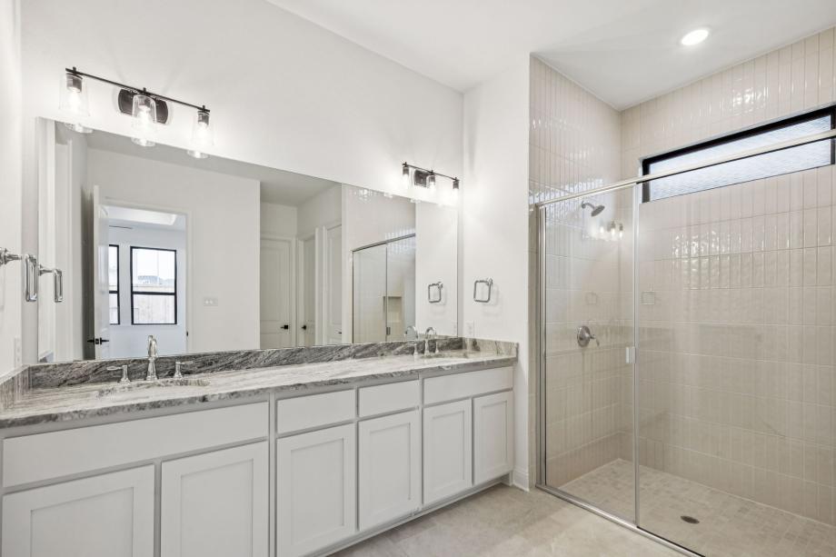 Luxurious primary bathroom with dual vanities