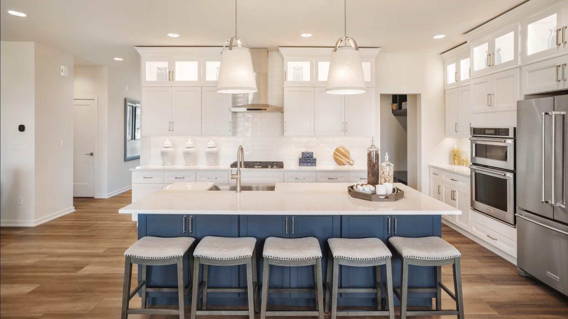 The open-concept kitchen, great room, and dining room are ideal for entertaining
