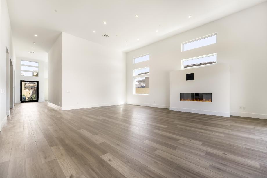 Expansive great room with linear fireplace and impressive 16' ceilings