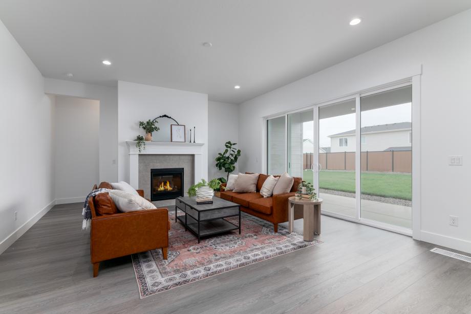 Inviting great room includes a gorgeous traditional fireplace with a tile surround