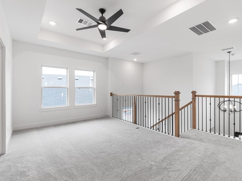 Upstairs loft area with tray ceilings
