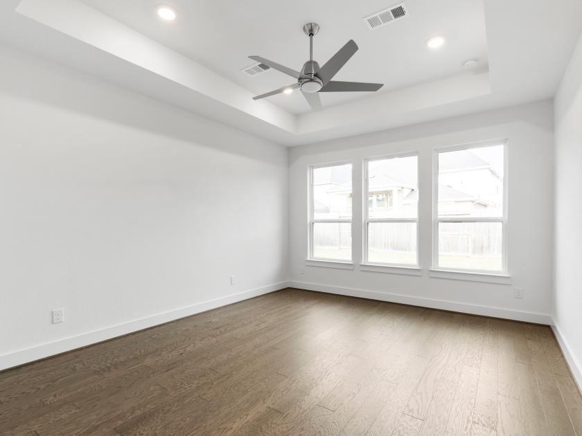 Primary bedroom with hardwood floors