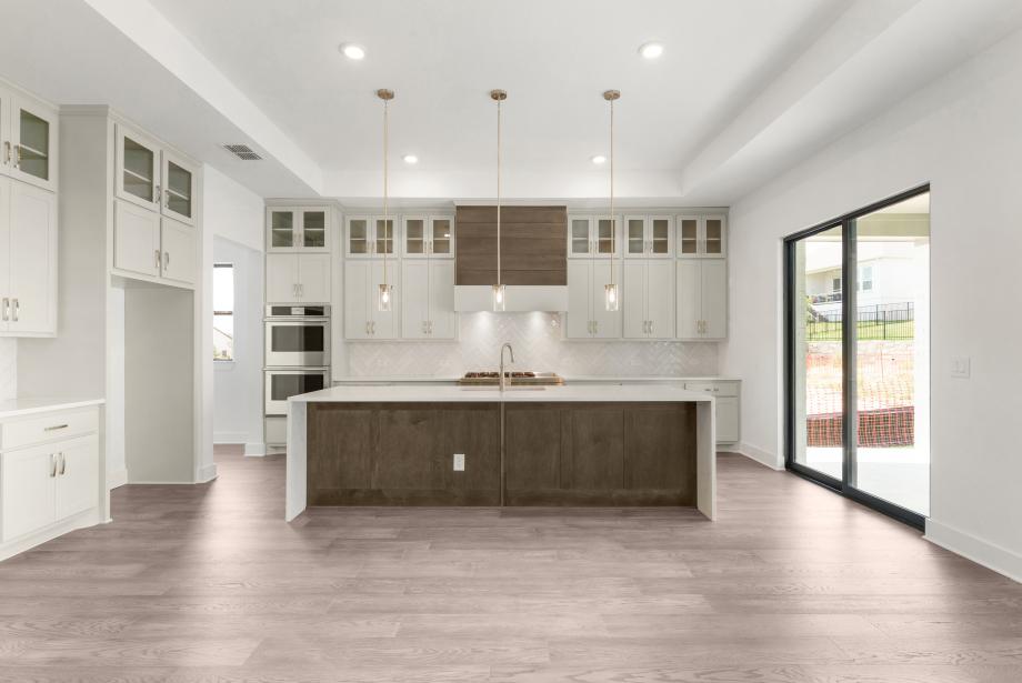Stunning tray ceiling in both the great room and gourmet kitchen