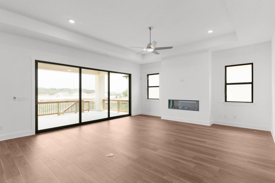 Spacious great room with a tray ceiling and expansive views of the covered patio