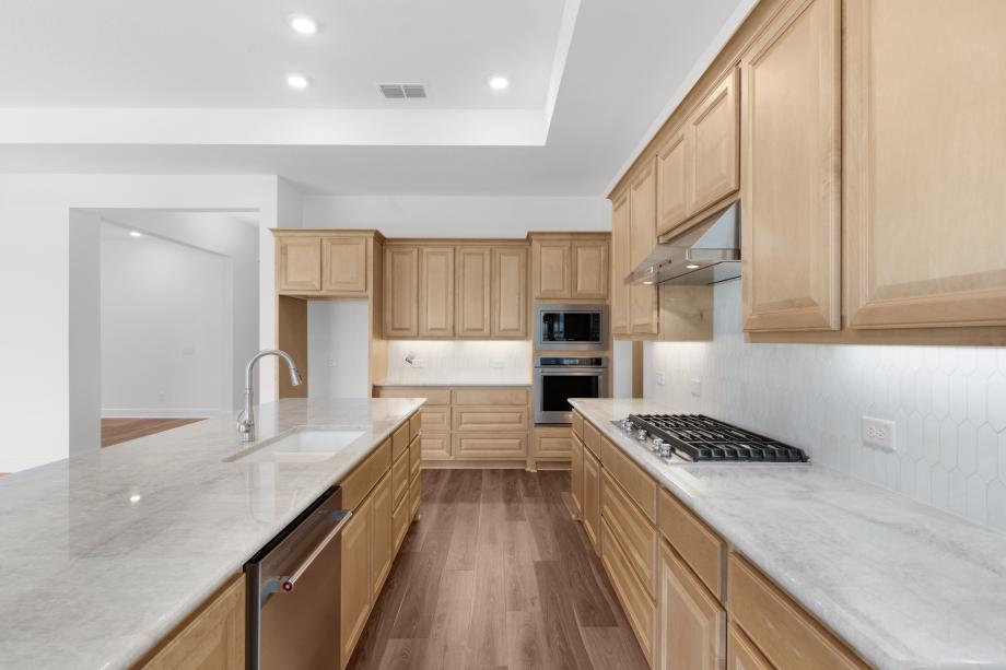Large center island with a breakfast bar and abundant counter and cabinet space